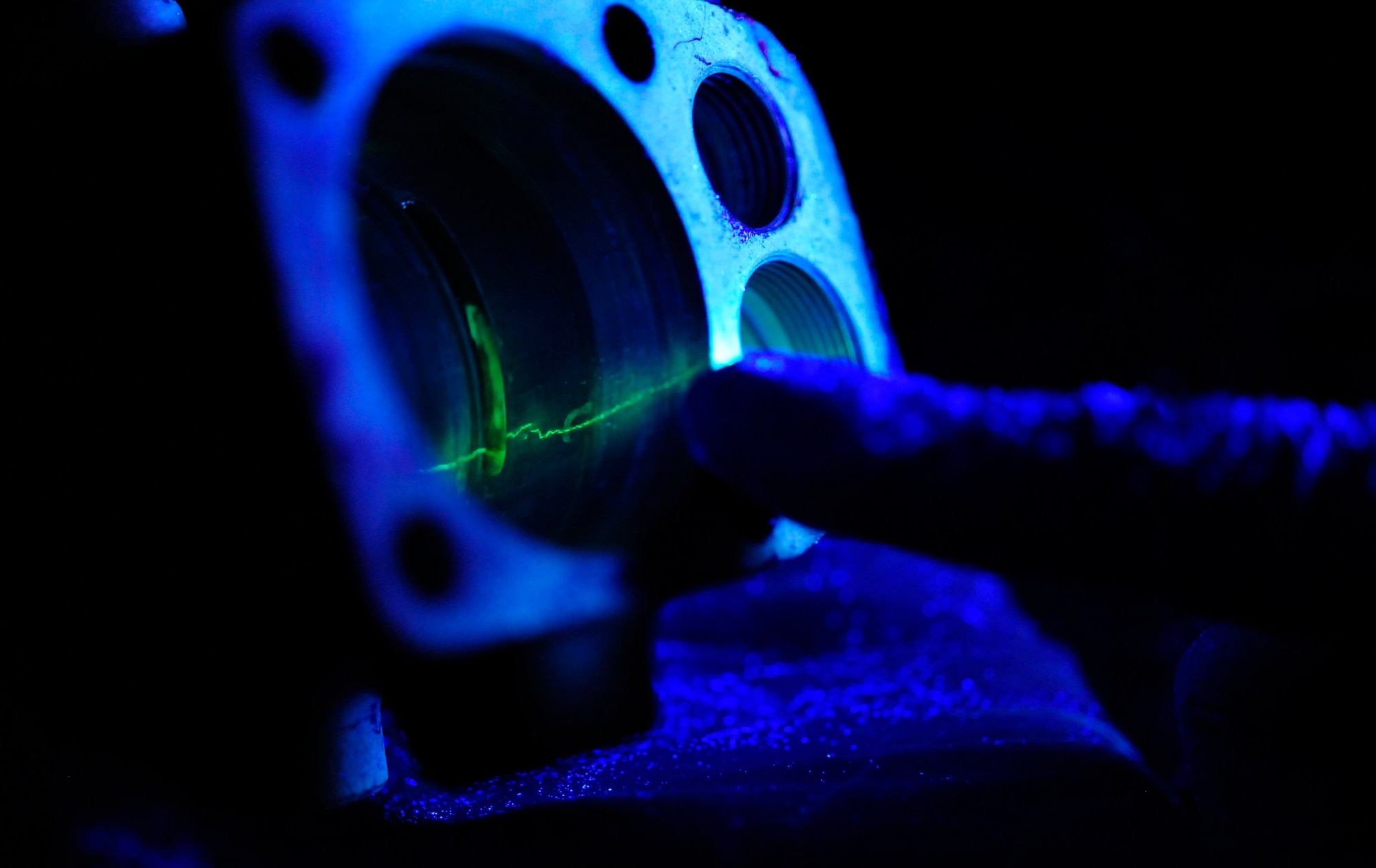 RAF MILDENHALL, England -- A KC-135 Stratotanker accumulator is examined under a black light during a fluorescent liquid penetrant inspection at RAF Mildenhall July 18, 2012. The black light highlights cracks in the landing gear, showing the exact location of the damage. (U.S. Air Force photo/Senior Airman Ethan Morgan)