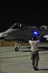U.S. Air Force Senior Airman Donte Slocum, 23d Aircraft Maintenance Squadron, 74th Aircraft Maintenance Unit crew chief, uses his batons to marshal the A-10C Thunderbolt II during Red Flag 12-4 at Nellis Air Force Base, Nev., July 20, 2012.  Airmen with the 23d AMXS/74th AMU provide 24 hour coverage during the Red Flag  exercise.  (U.S. Air Force photo by Staff Sgt. Stephanie Mancha/Released)