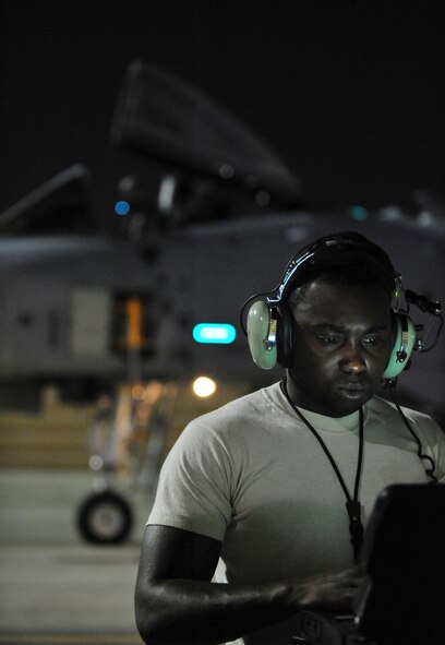 U.S. Air Force Senior Airman Donte Slocum, 23d Aircraft Maintenance Squadron, 74th Aircraft Maintenance Unit crew chief, inputs data onto his lap top before a night mission at Nellis Air Force Base, Nev., July 20, 2012. Slocum is station at Moody AFB,Ga., and is participating in Red Flag 12-4. This is Solcum first Red Flag exercise. (U.S. Air Force photo by Staff Sgt. Stephanie Mancha/Released)