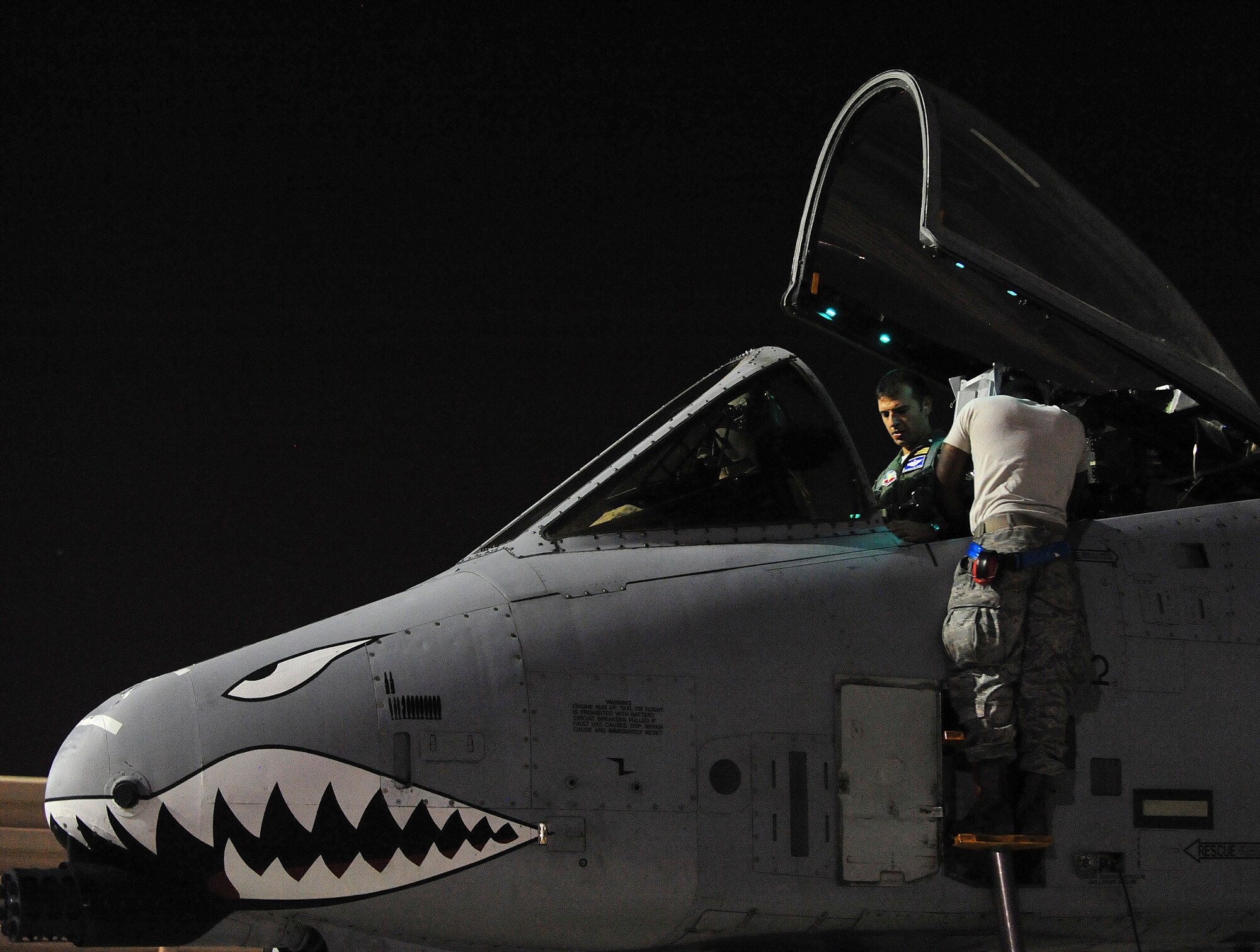 U.S. Air Force Senior Airman Donte Slocum, 23d Aircraft Maintenance Squadron, 74th Aircraft Maintenance Unit crew chief, assist Italian air force exchange pilot Capt. Maurizio De Guida, 74th Fighter Squadron,  before take off during Red Flag 12-4 exercise at Nellis Air Force Base, Nev., July 20, 2012. De Guida and Slocum are both station at Moody AFB,Ga., and are participating in Red Flag; a realistic aerial combat training exercise that test the limits of man and machine as they conduct training on air interdiction, combat search and rescue, dynamic and high value targeting. (U.S. Air Force photo by Staff Sgt. Stephanie Mancha/Released)