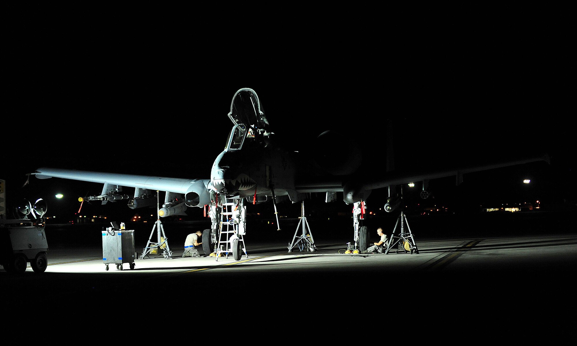 U.S. Air Force Airmen from the 23d Aircraft Maintenance Squadron, 74th Aircraft Maintenance Unit, repair the brakes on an A-10C Thunderbolt II during Red Flag 12-4 at Nellis Air Force Base, Nev., July 20, 2012. The pilot on the A-10 reported that the brakes weren't working properly during the post-inspection and the crew chief worked with the maintenance specialist to fix the aircraft. (U.S. Air Force photo by Staff Sgt. Stephanie Mancha/Released)