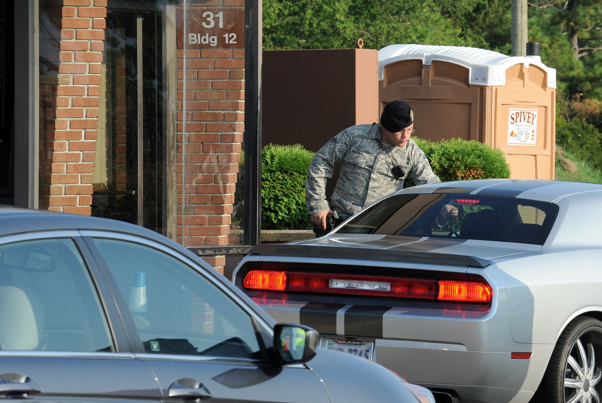 Senior Airman Chad Hussey, 633rd Security Forces Squadron gate guard, confirms the identity of personnel at the LaSalle Gate before granting them access to Langley Air Force Base, Va., July 24. This gate will close to all traffic for approximately six months, beginning Aug. 13, due to the construction of a new, state-of-the-art visitor’s center. (U.S. Air Force photo by Tech. Sgt. Randy Redman/Released)
