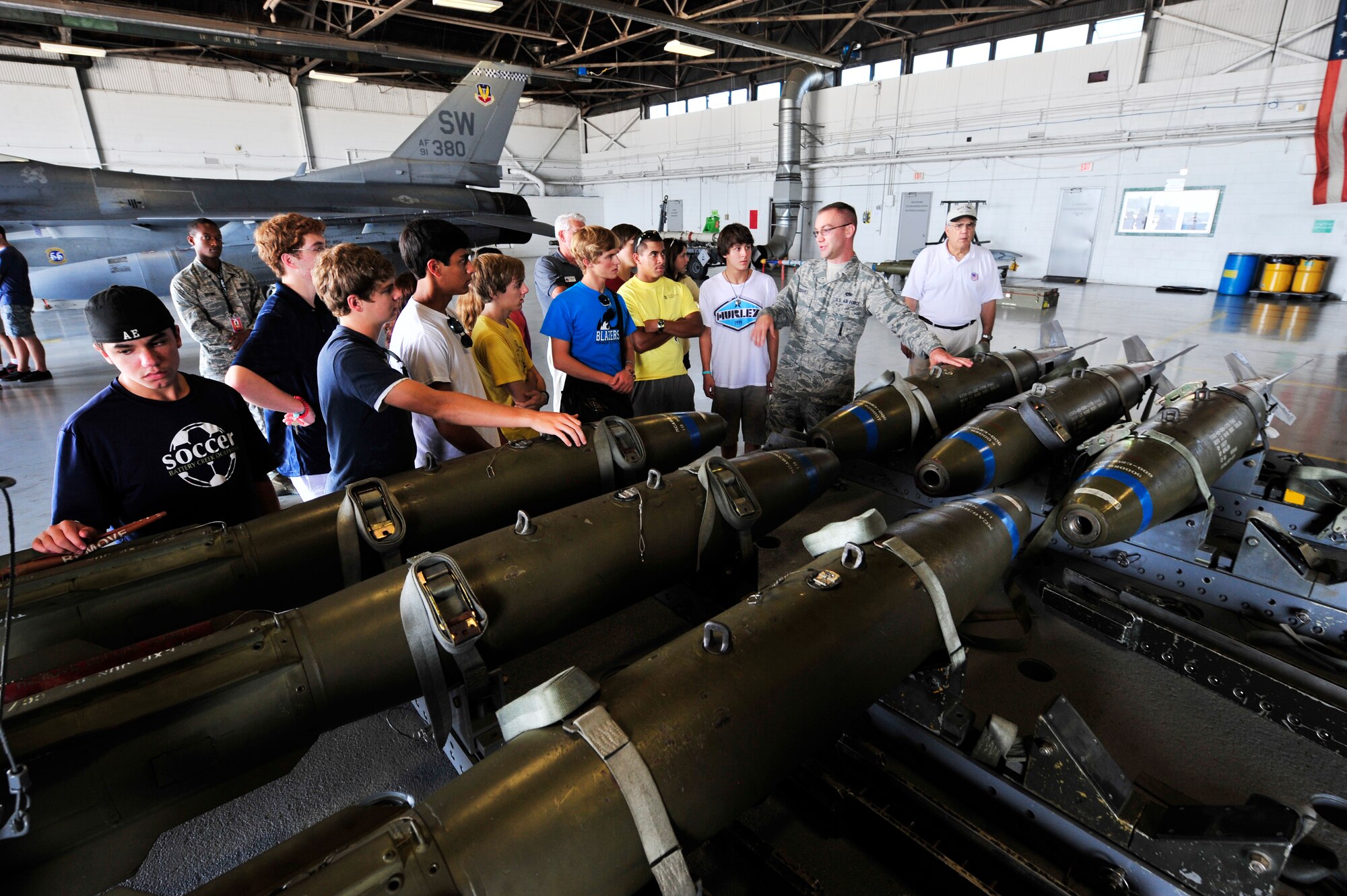 U.S. Air Force Tech. Sgt. Jason Tremmel, 20th Maintenance Operation Squadron weapons expediter, gives a tour of the loading barn hangar to students from the Celebrate Freedom Foundation's aviation aerospace summer camp,  Shaw Air Force Base, S.C., July 17, 2012. During their tour the group visited the load barn, the 20th Civil Engineer Explosive Ordnance Disposal unit and the 20th Operation Support Squadron Weather Flight.(U.S. Air Force photo by Airman Nicole Sikorski/Released) 