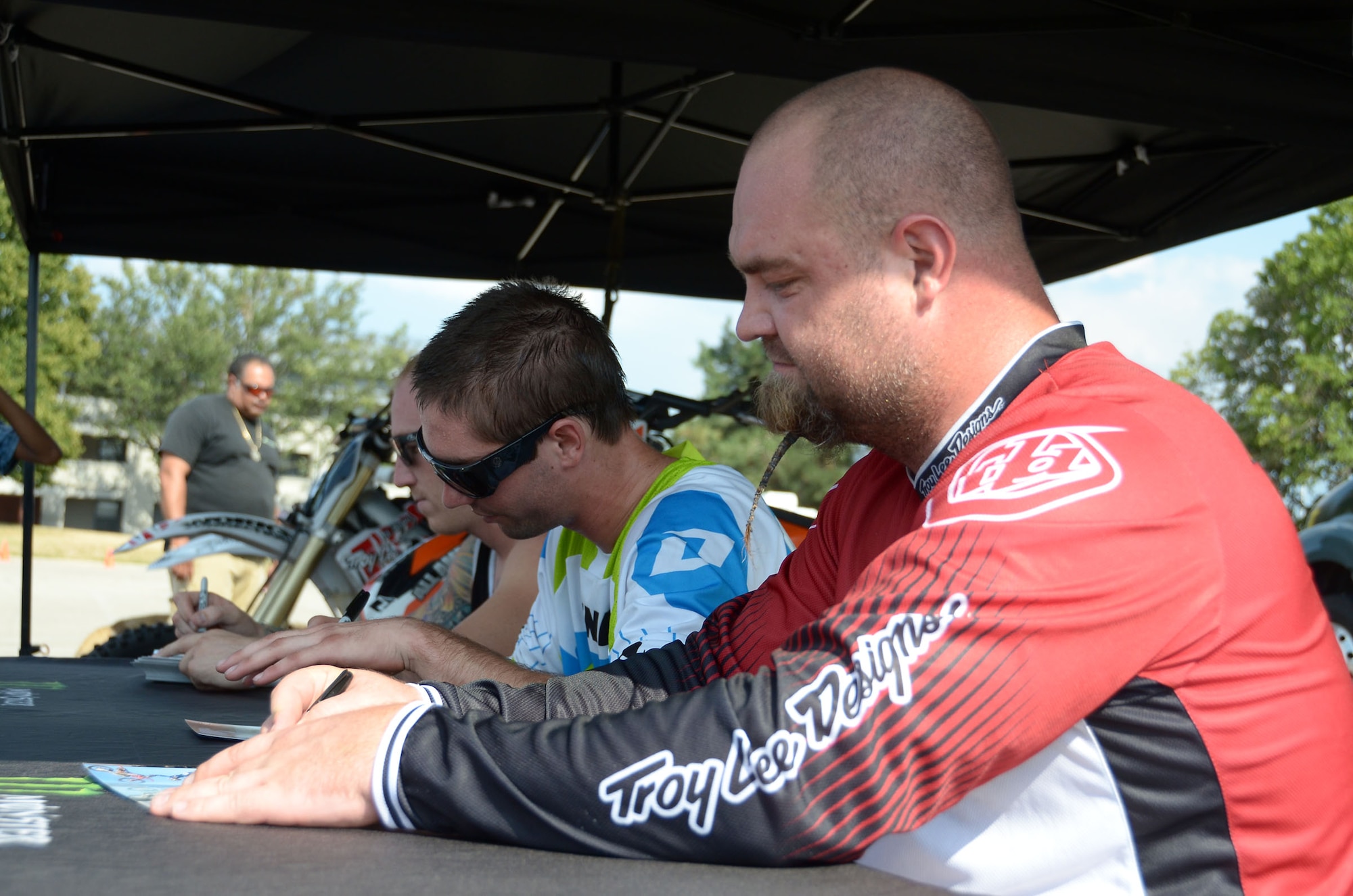 WRIGHT-PATTERSON AIR FORCE BASE, Ohio – 445th Airlift Wing reservists and their families had an opportunity to meet motocross riders (from left to right) Rich Kearns, Bryce Hudson and John Distler at the Base Exchange at Wright-Patterson Air Force Base, Ohio, July 16 and 17. The three signed autographs and performed various stunts for the base community. (U.S. Air Force photo/Staff Sgt. Mikhail Berlin)