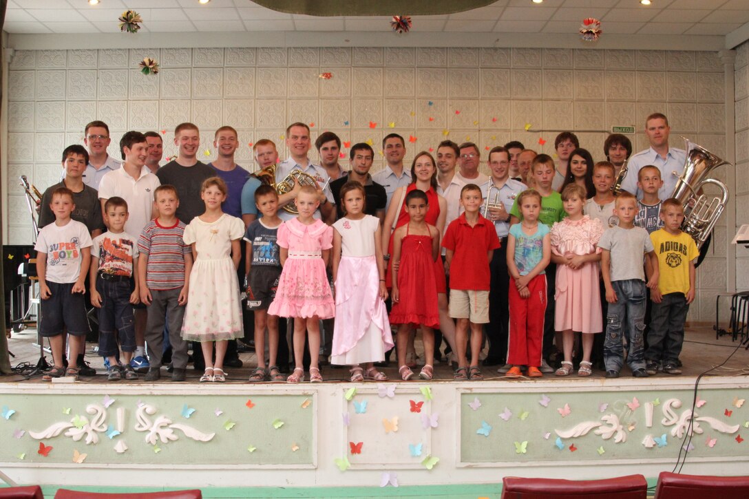 The Five Star Brass performed for an orphanage for musically gifted children.  Pictured with the Brass are teachers, students and recent graduates of the program.