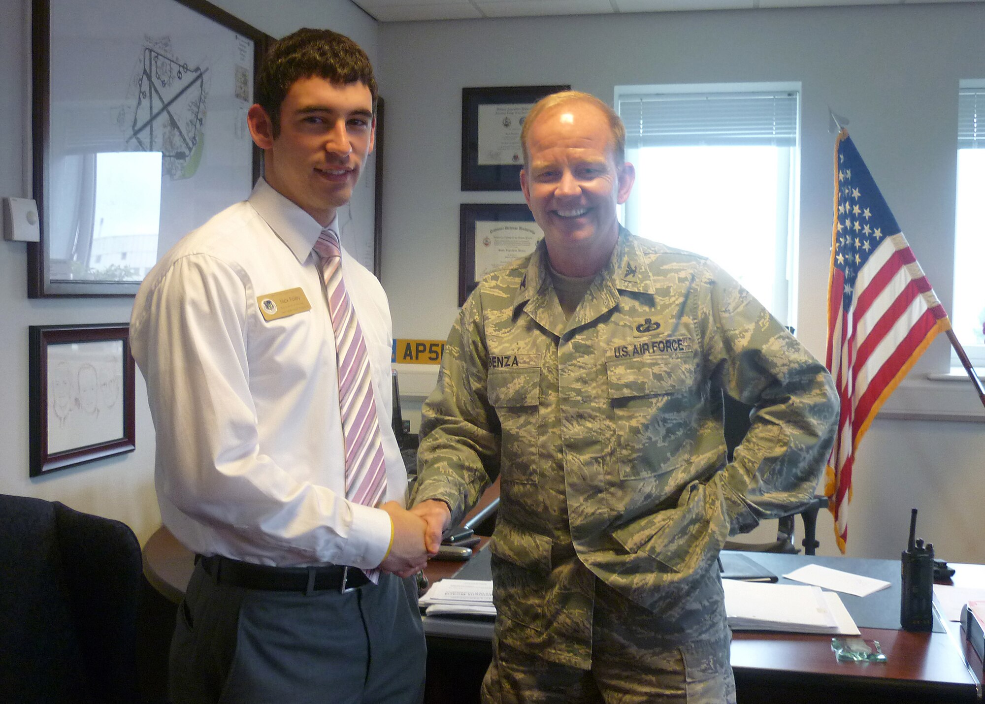 ROYAL AIR FORCE LAKENHEATH, England - Nicholas Foley, 2011 Boys & Girls Clubs of America National Youth of the Year (left), shakes hands with Col. Scott Benza, 48th Mission Support Group commander July 17, 2012. Foley's visit was part of the Headquarters United States Armed Forces in Europe Summer Leadership Assistant Program. (Courtesy photo)