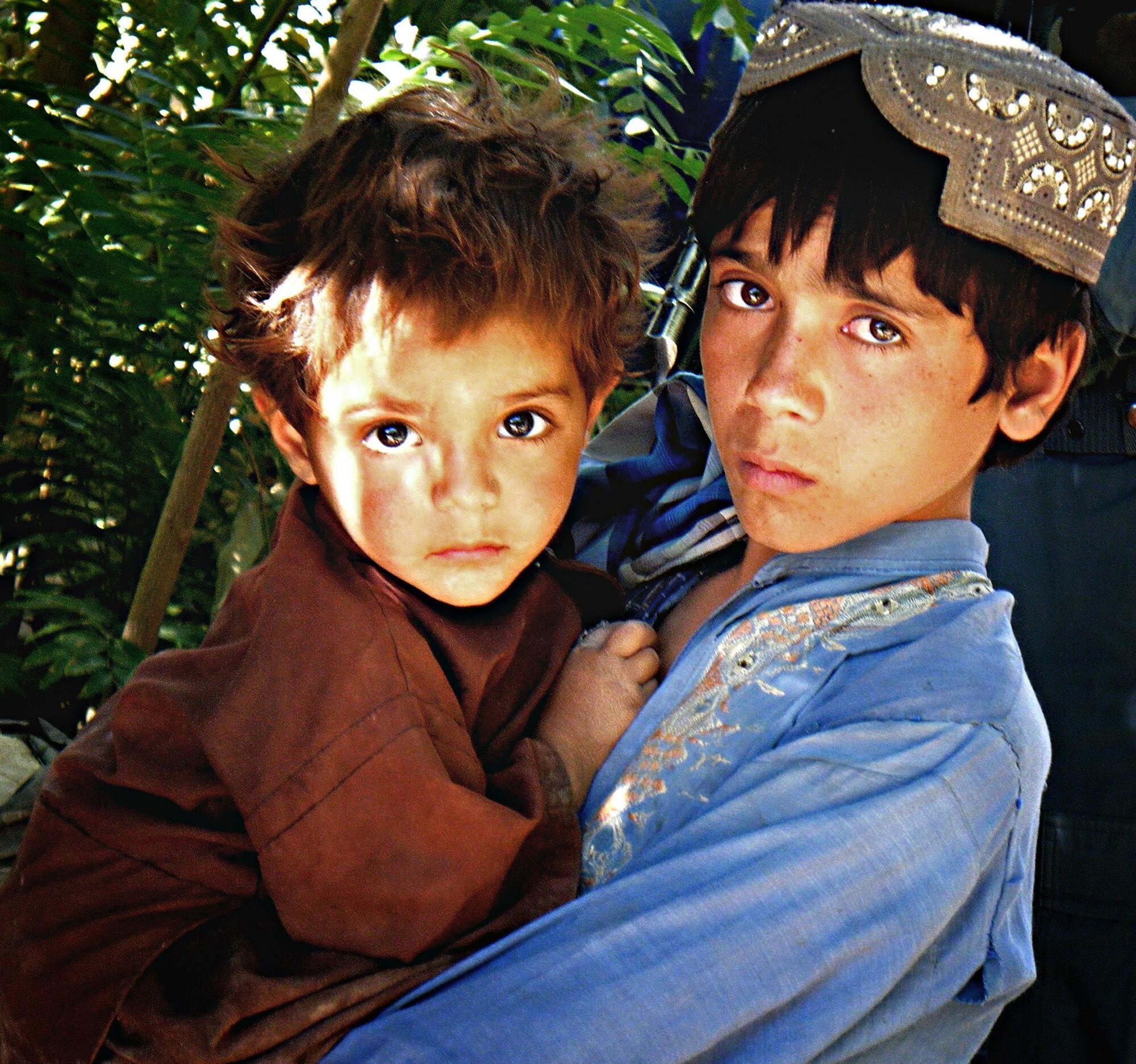 Afghan brothers wait for their father to come out of a community meeting in Afghanistan’s Zabul province. (Courtesy photo/Maj. John Matthews) 