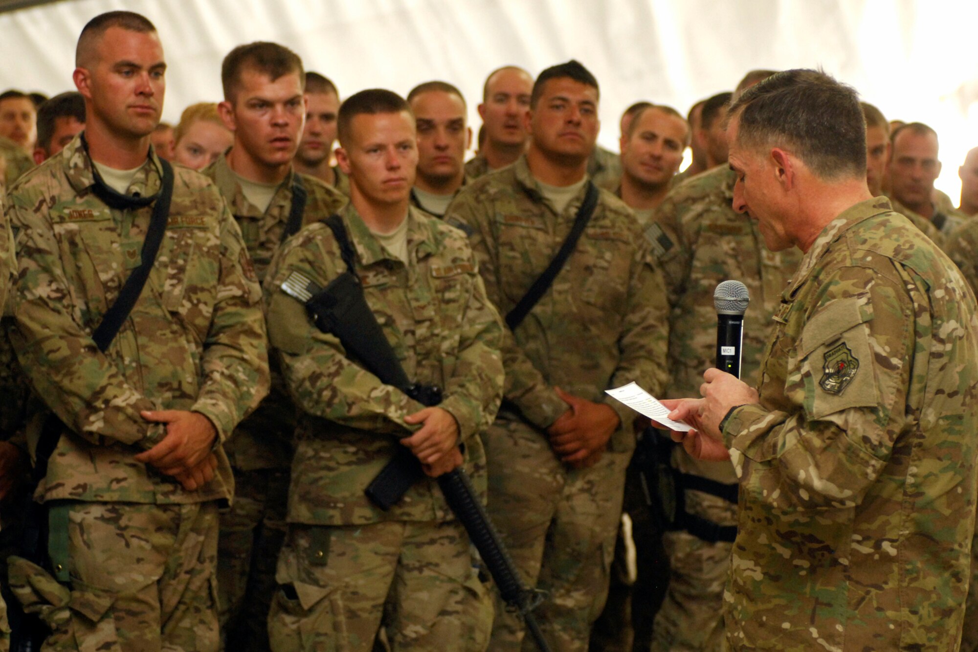 Personnel from of the 455th Expeditionary Maintenance Group listen as Lt. Gen. David Goldfein, Commander, U.S. Air Forces Central Command, reads a letter from a U.S. Army Soldier during his visit to Bagram Airfield, Afghanistan, July 23, 2012. In the letter, the Soldier thanks the Air Force for providing air support during a mission in Afghanistan. By reading the letter, Goldfein wanted to convey to the Airmen that their hard work is noticed. (U.S. Air Force photo/SSgt Jeff Nevison)