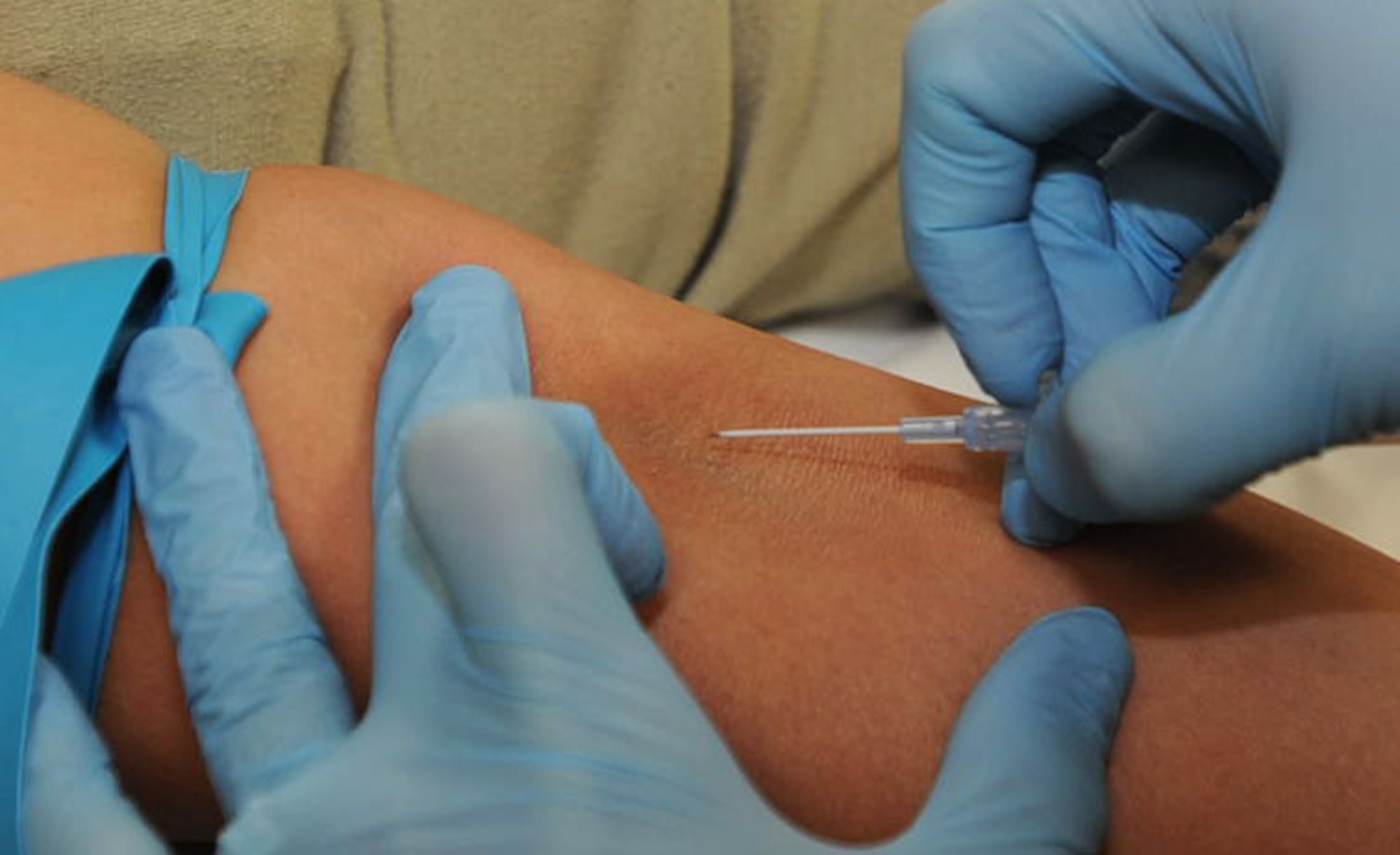 A U.S. Air Force Airman prepares to stick an IV into a patient’s vein in preparation for a CT scan at Misawa Air Base, Japan, July 24, 2012. There are two different types of CT scans; one involves an IV contrast and one does not. The IV contrast enhances the blood vessels and enables technologists to check for blood clots. The IV also allows the technologists to double check certain masses spotted in previous images, which could include cancer and other pathology. (U.S. Air Force photo by Airman 1st Class Kenna Jackson/Released)