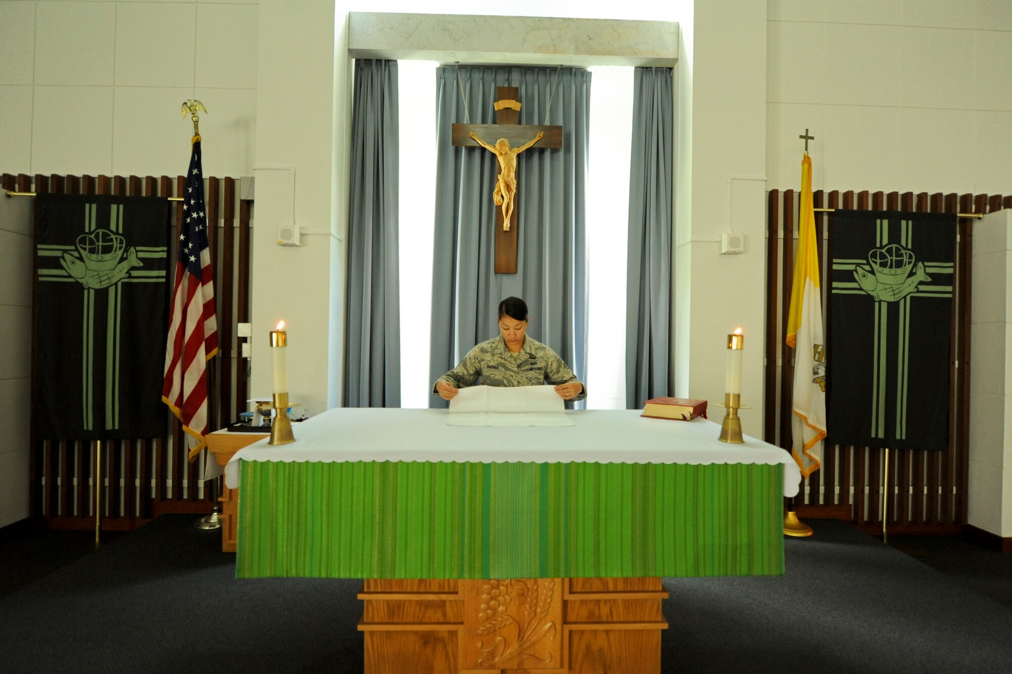 U.S Air Force Staff Sgt. Rachel Barnes, a Reservist serving as an 18th Wing chaplain assistant, sets up Chapel 1 for a Catholic service on Kadena Air Base Japan, July 24, 2012. Barnes earned the Citizen Airman Award for 2011 for the Reservist Chaplain Assistant category. (U.S. Air Force photo/Airman 1st Class Brooke P. Beers)