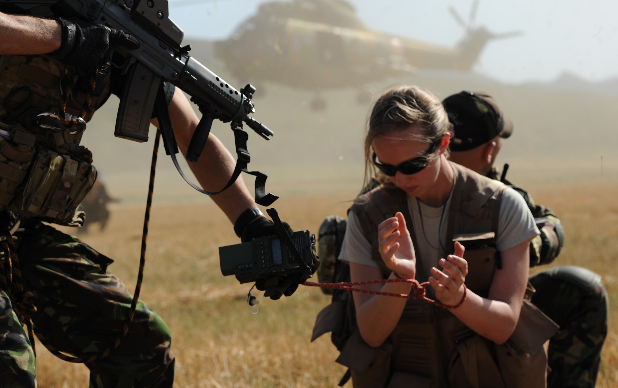 CAMPIA TURZII, Romania -- Romanian air force special forces members use their nation’s combat search and rescue procedures to identify U.S. Air Force Capt. Maureen Hartney, 81st Fighter Squadron executive officer, as a survivor July 19 during a training mission a part of the Dacian Thunder exerise here. The 81st FS A-10 Thunderlbolt II pilots worked with Romanian air force IAR helicopter pilots to locate and safely rescue Hartney in this mission. Dacian Thunder is a month-long partnership building exercise in which the U.S. Air Force, Romanian air force, U.S. Marine Corps and the Royal Air Force exchange techniques, tactics and procedures to strengthen coalition and joint capabilities. Faces have been blurred to protect the identity of special forces members. (U.S. Air force photo by Senior Airman Natasha Stannard/Released)