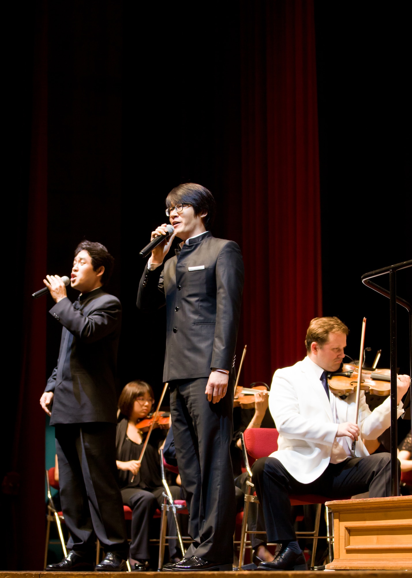 Singers performing with the Gunsan Philharmonic Orchestra entertain the crowd July 20, 2012, in Gunsan City, South Korea. Classical numbers from the orchestra were combined with vocal performances from singers and a poet. (U.S. Air Force photo/Tech. Sgt. Kevin Crawford)