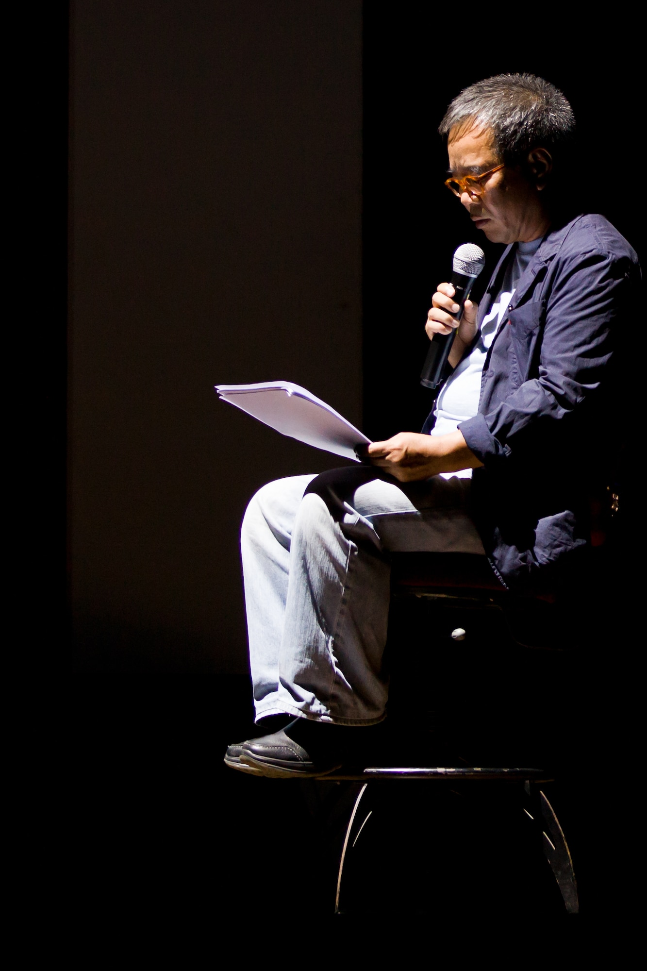 A poet reads some of his work during a show by the Gunsan Philharmonic Orchestra July 20, 2012, in Gunsan City, South Korea. Classical numbers from the orchestra were also combined with vocal performances. (U.S. Air Force photo/Tech. Sgt. Kevin Crawford)