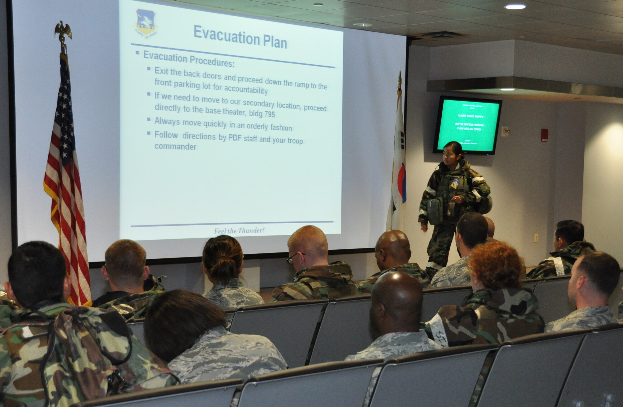 Senior Airman Alta Fred Inocencio, 51st Force Support Squadron, briefs inbound personnel during operational readiness exercise Beverly Midnight 12-03 at Osan Air Base, Republic of Korea, July 24, 2012. Throughout the week, Osan Mustangs demonstrate the ability to operate in a chemical environment as well as administer self-aid and buddy-care during a wartime environment. Airmen also highlight their ability to position, employ, and sustain forces and showcase operational readiness. (U.S. Air Force photo/Senior Airman Michael Battles)