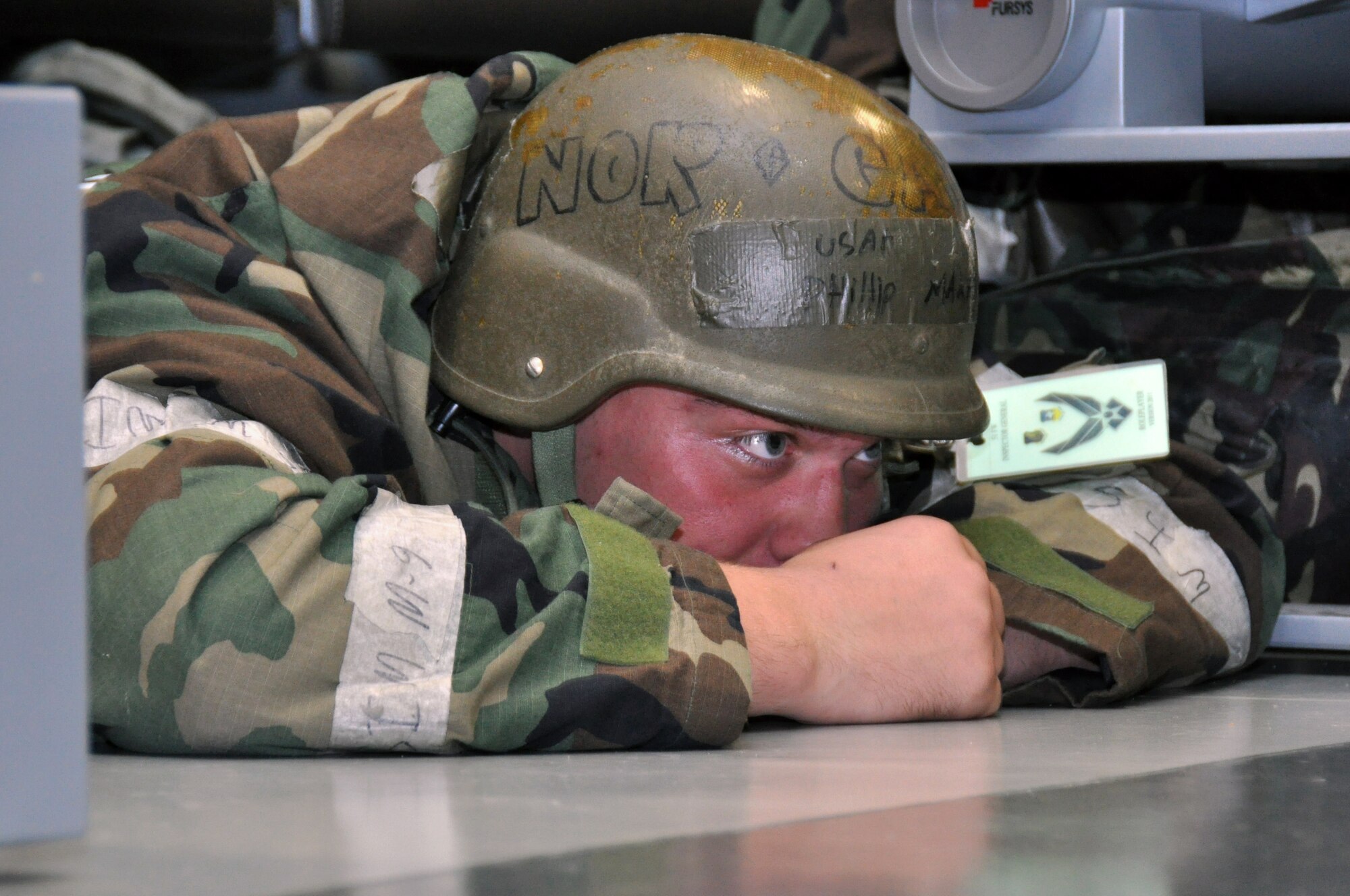 Airman 1st Class Phillip Makarenko, 51st Munitions Squadron, takes cover during a mortar attack part of operational readiness exercise Beverly Midnight 12-03 at Osan Air Base, Republic of Korea, July 24, 2012. During the week, Airmen will showcase their ability to position, employ and sustain forces during a variety of simulated attacks and situations. Participants also demonstrate the ability to administer self-aid and buddy-care and operate in a chemical environment. (U.S. Air Force photo/Senior Airman Michael Battles)