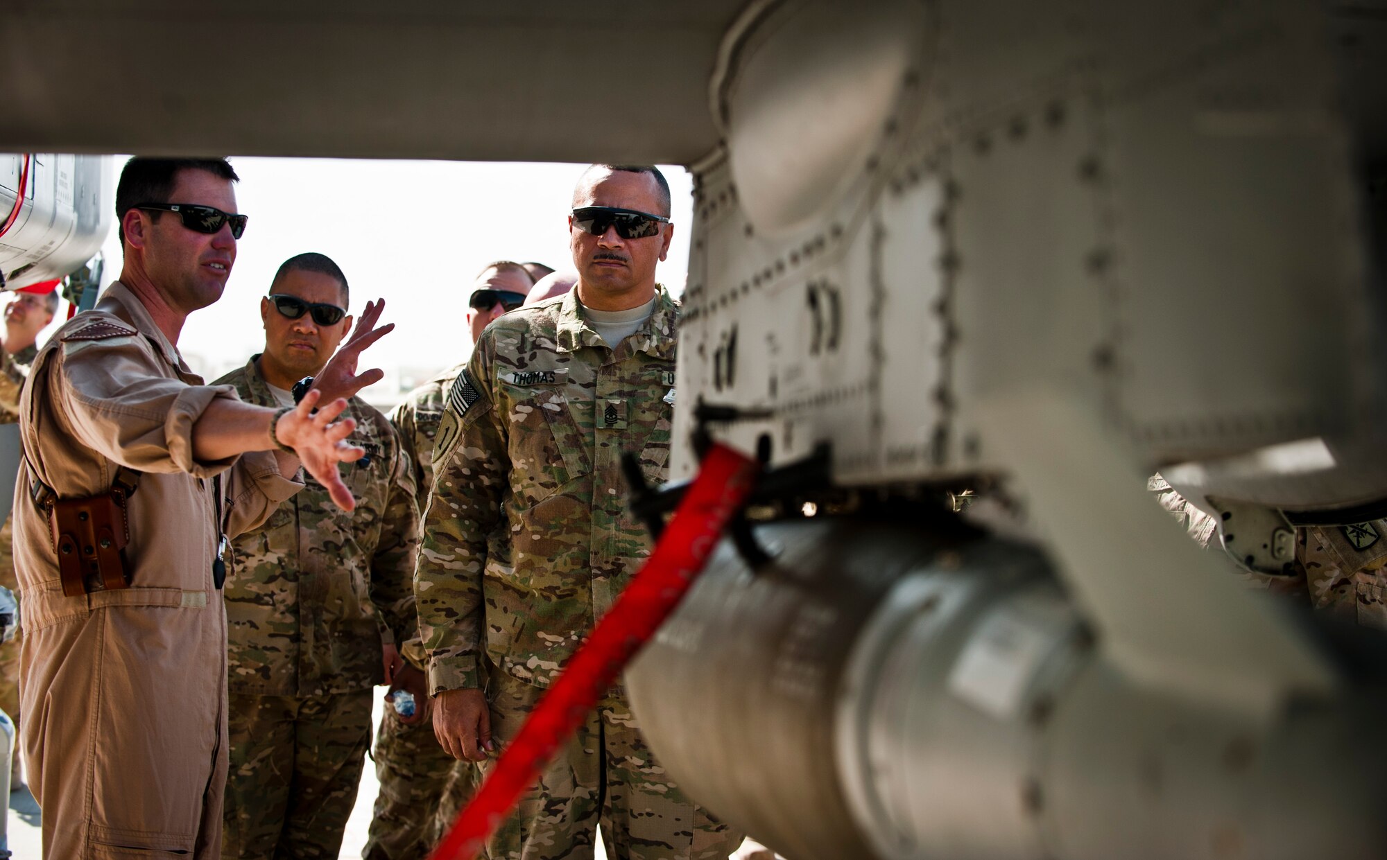 A pilot assigned to the 104th Expeditionary Fighter Squadron shows a U.S. Air Force A-10 Thunderbolt II to a visiting group of senior enlisted leaders during a 455th Air Expeditionary Wing orientation tour at Bagram Airfield, Afghanistan, July 21, 2012. The visit gave the senior enlisted leaders a better understanding of the A-10s capabilities to support the warfighter on the ground. (U.S. Air Force Photo/Capt. Raymond Geoffroy)