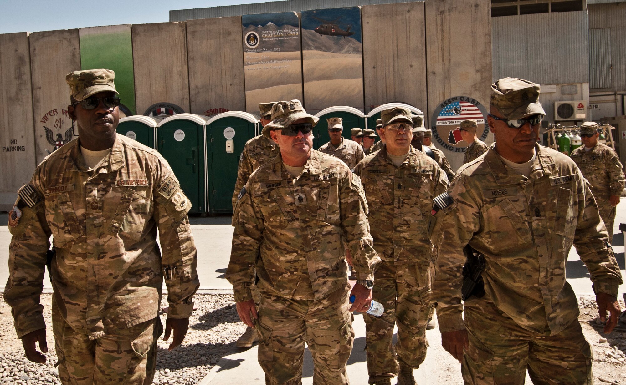 Command Sergeant Major Charles Sasser Jr., CJTF-1 and Regional Command-East CSM, Chief Master Sgt. Marcus Snoddy, 455th Air Expeditionary Wing command chief and a group of senior enlisted leaders walk into the Contingency Aero-medical Staging Facility during a 455 AEW orientation tour at Bagram Airfield, Afghanistan, July 21, 2012. The tour gave Bagram senior enlisted leaders insight into the contributions of Bagram Airmen. (U.S. Air Force Photo/Capt. Raymond Geoffroy)