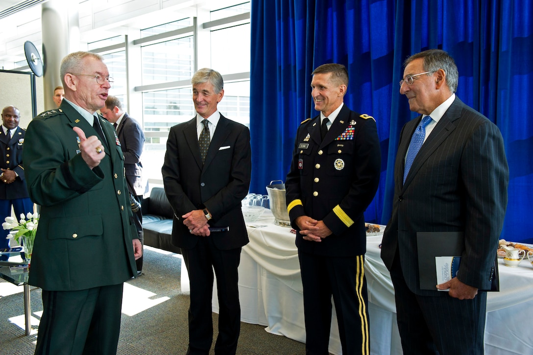 Defense Secretary Leon E. Panetta, right, speaks with Army Lt. Gen. Ronald L. Burgess Jr., left, Army Lt. Gen. Michael T. Flynn, second from right, and Army Secretary John M. McHugh, second from left, before the change of directorship for the Defense Intelligence Agency on Joint Base Anacostia-Bolling in Washington, D.C., July 24, 2012. Burgess turned over the agency's directorship to Army Lt. Gen. Michael T. Flynn.