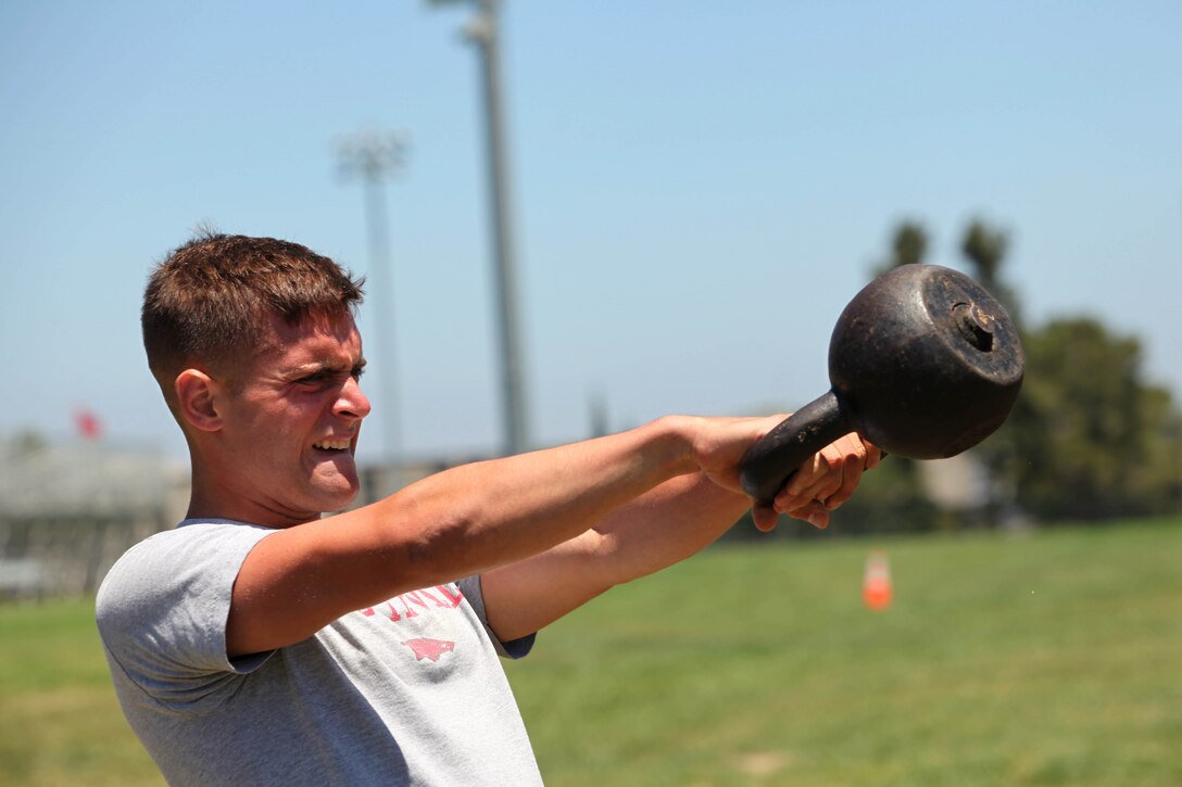 Lance Cpl. Ben Lowry, assistant gunner with Low Altitude Air Defence Battalion, Marine Air Wing, performs kettle-bell exercises during the Cobat Conditioning Training Course at the Paige Field House on Marine Corps Base Camp Pendleton, July 24.