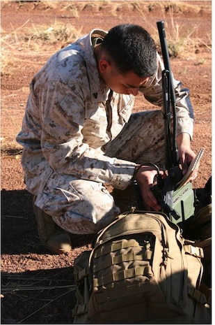 Cpl. Mark A. Vega, a 5th Air Naval Gunfire Liaison Company, 3rd Brigade, Supporting Arms Liaison Team Fox field radio operator, conducts a radio check to establish communication with aircraft here July 23 as part of Exercise Southern Frontier 2012. Fox Company, 2nd Battalion, 3rd Marines, also joined the exercise by incorporating mortar support.