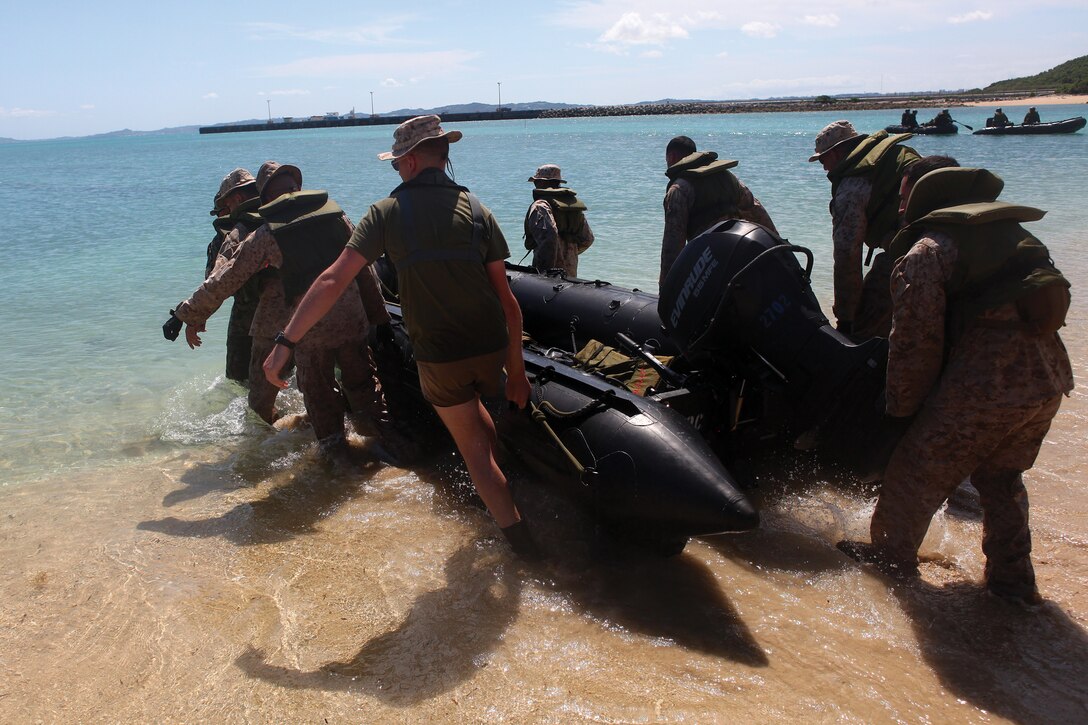 Marines launch a combat rubber raiding craft into the ocean during a coxswain course at White Beach Naval Facility May 23. During the course, the Marines familiarized themselves with every part of the CRRCs and their operations.