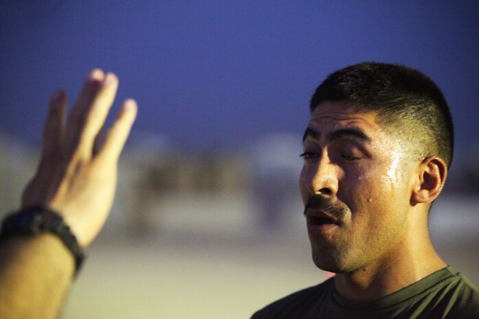 Cpl. Raphael Padilla, an Arlington, Va., native and food service specialist with Combat Logistics Battalion 24, 24th Marine Expeditionary Unit, opens his eyes after being sprayed with oleoresin capsicum, or OC spray, during a level one OC spray certification in Kuwait, July 17, 2012. The Marines are in Kuwait conducting a variety of sustainment training exercises that started in early June and will continue throughout the summer months. The 24th MEU is deployed with the Iwo Jima Amphibious Ready Group as a U.S. Central Command theater reserve force providing support for maritime security operations and theater security cooperation efforts in the U.S. 5th Fleet area of responsibility.