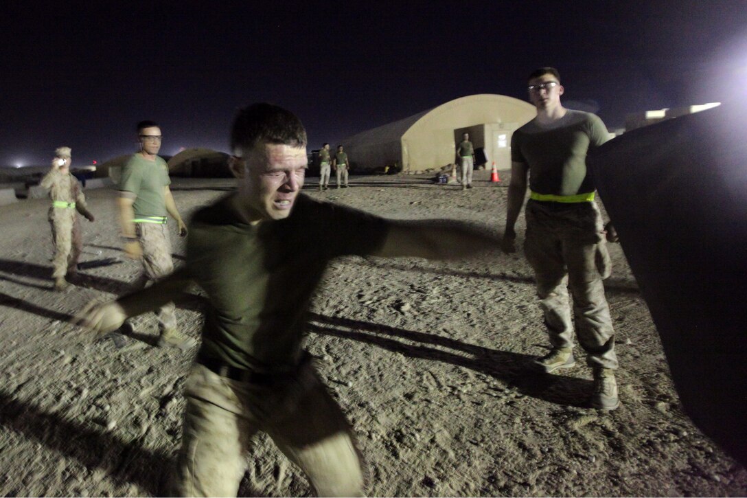 Sgt. Matt Michaelre, a St. Louis, Mo., native and combat engineer with Combat Logistics Battalion 24, 24th Marine Expeditionary Unit, strikes a pad after being sprayed with oleoresin capsicum, or OC spray, during a level one OC spray certification in Kuwait, July 17, 2012. The Marines are in Kuwait conducting a variety of sustainment training exercises that started in early June and will continue throughout the summer months. The 24th MEU is deployed with the Iwo Jima Amphibious Ready Group as a U.S. Central Command theater reserve force providing support for maritime security operations and theater security cooperation efforts in the U.S. 5th Fleet area of responsibility.
