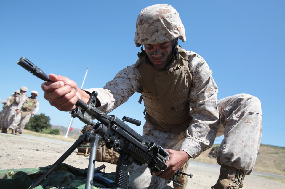 MARINE CORPS BASE CAMP PENDLETON, Calif. – Sgt. Michael T. Carradine, a student with 1st Platoon, Class 4-12, Sergeant’s Course, Staff Non-Commissioned Officer Academy Camp Pendleton, disassembles a M249 Light Machine Gun during the Course’s culminating event aboard the base, June 6, 2012. The culminating event tested the sergeants on many of the topics and portions of the course curriculum to include, land navigation, call for fire and tactical evacuation of wounded. (U.S. Marine Corps photo by Sgt. Christopher O’Quin/Released)