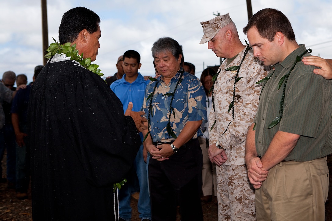 (From left) Kahu (Hawaiian minister) Curt Pa’alua Kekuna, Lloyd Arakaki, principal at Architects Hawaii, Ltd., Col. Brent S. Willson, commander of Headquarters and Service Battalion, U.S. Marine Corps Forces, Pacific, and Dave Ott, AMEC vice president, pray together during a blessing ceremony at the construction site of the new fitness center here July 18. The fitness center is expected to be open by August 2013.