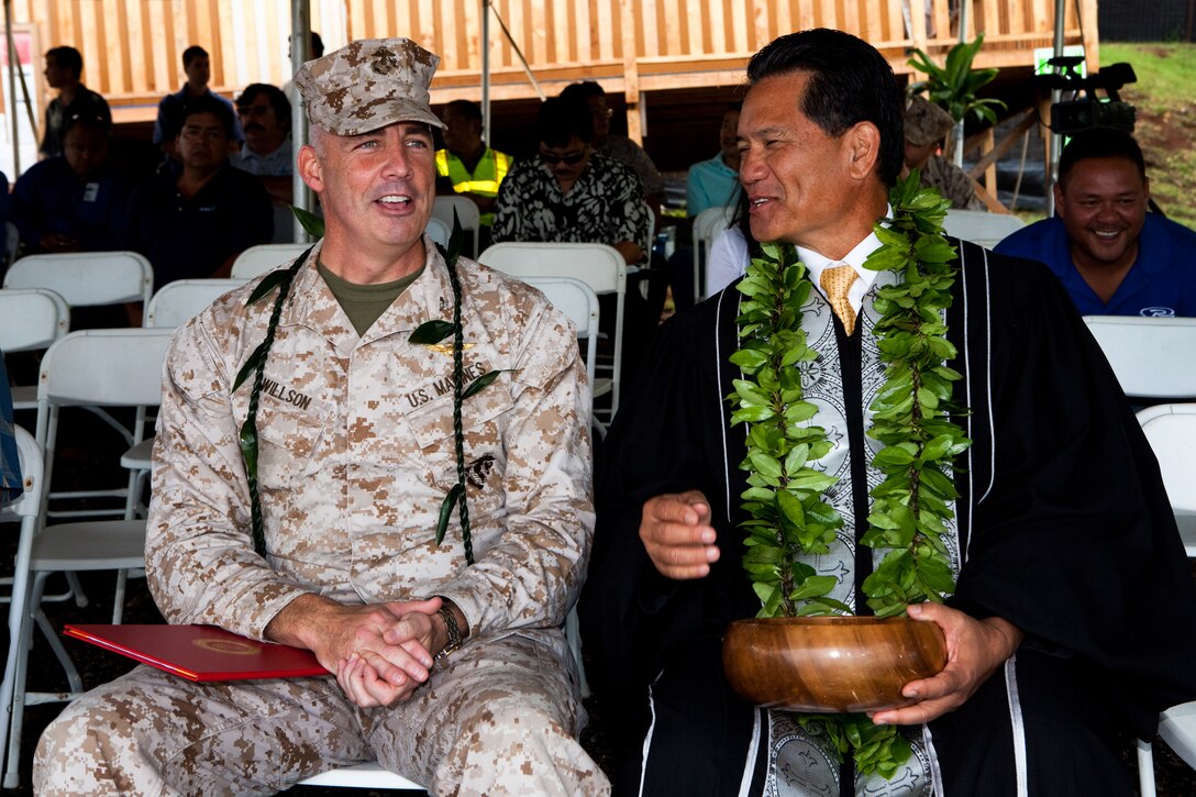 Col. Brent S. Willson, commander of Headquarters and Service Battalion, U.S. Marine Corps Forces, Pacific, and Kahu (Hawaiian term for minister) Curt Pa’alua Kekuna, chat before a blessing ceremony here July 18. They gathered to bless the construction of the new fitness center, which is expected to be open by August 2013. 