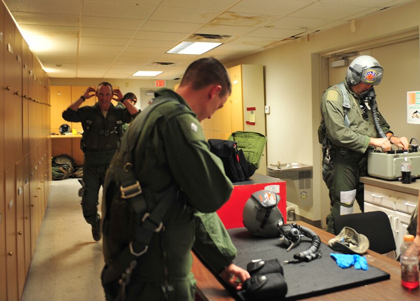 U.S. Air Force A-10C Thunderbolt II pilots with the 74th Fighter Squadron from Moody Air Force Base, Ga., test their equipment before heading to the flightline during the Red Flag 12-4 exercise at Nellis AFB, Nev., July 23, 2012. The pilots use a Scot tester before every mission to check the airflow of the mask, oxygen levels and to ensure their headset is working properly. (U.S. Air Force photo by Staff Sgt. Stephanie Mancha/Released)