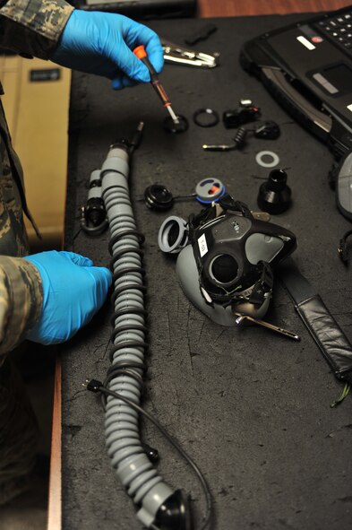 U.S. Senior Airman Scott Waclawk, 23d Operations Support Squadron aircrew flight equipment technician, completely breaks down an oxygen mask of an aircrew member during the Red Flag 12-4 exercise at Nellis AFB, Nev., July 23, 2012. Five AFE technicians are deployed here from Moody in support of the 74th Fighter Squadorn. (U.S. Air Force photo by Staff Sgt. Stephanie Mancha/Released)