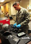 U.S. Senior Airman Scott Waclawk, 23d Operations Support Squadron aircrew flight equipment technician, inspects the helmet and oxygen mask of an aircrew member during the Red Flag 12-4 exercise at Nellis AFB, Nev., July 23, 2012. The AFE technicians continue to perform their 30 day inspections and have completed 17 full sets, which include the helmet, mask and harness. (U.S. Air Force photo by Staff Sgt. Stephanie Mancha/Released)
