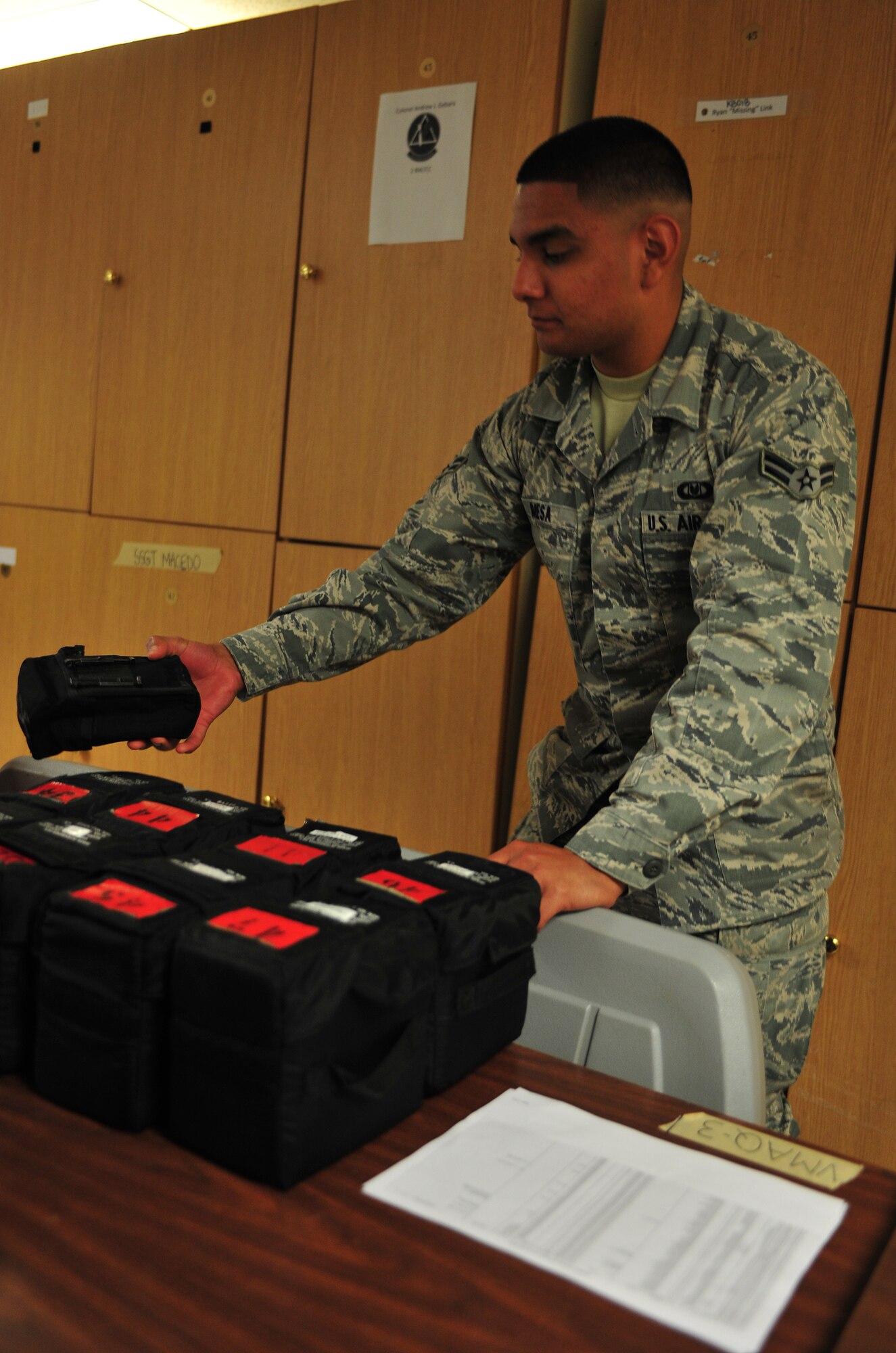 U.S. Airman 1st Class Andrew Mesa, 23d Operations Support Squadron aircrew flight equipment technician, displays the night vision goggles on a table for  A-10C Thunderbolt II pilots to pick up before heading to the flightline during the Red Flag 12-4 exercise at Nellis AFB, Nev., July 23, 2012. Thirty one A-10 pilots attached to 74th Fighter Squadron from Moody AFB, Ga., are deployed in support of the Red Flag exercise. (U.S. Air Force photo by Staff Sgt. Stephanie Mancha/Released)