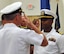 Lt. Cmdr. Eric Cottrell, right,  assumes command of the Navy Operational Support Center, Moreno Valley, a tenant unit at March Air Reserve Base, Calif., July 20. Prior to his arrival, Cottrell served as the deputy executive assistant to the Chief of Navy Reserve. During his career, Cottrell was also assigned to the Littoral Combat Ship Squadron Mine Countermeasure Mission Package Detachment Two and Afloat Training Group Pacific. He served aboard the USS Peleliu (LHA-5), USS Kauffman (FFG-59), USS Nashville (LPD-13) and the USS Antrim (FFG-20). The unit hailed Cottrell, wife Yvonne and son Ellis. (U.S. Air Force photos by Darnell Gardner)