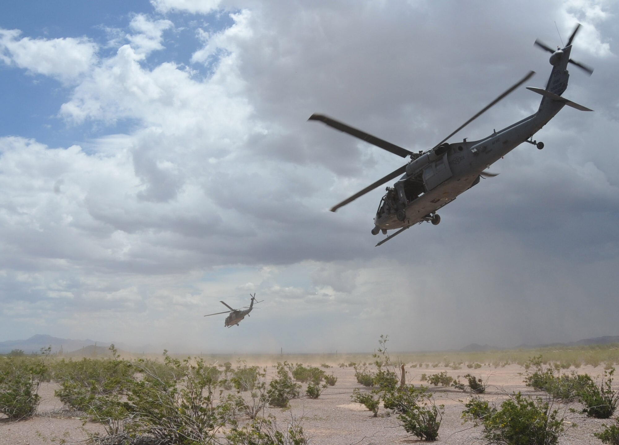 Two HH-60 Pave Hawk helicopters from the 305th Rescue Squadron fly low over the Sonoran Desert outside of Tucson, Ariz. during a training mission.  The 305th RQS is an Air Force Reserve unit located at Davis-Monthan Air Force Base Ariz. and is assigned to the 943rd Rescue Group.  The squadron is capable of performing day or night combat rescue mission along with providing humanitarian and disaster relief operation support. (U.S. Air Force photo/ Master Sgt. Luke Johnson) 