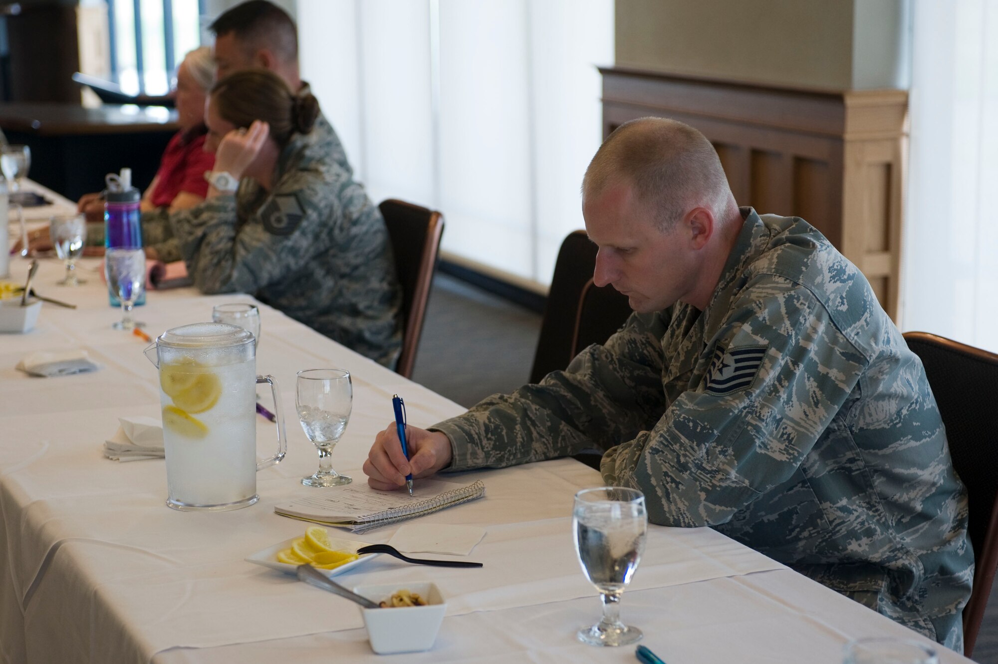 U.S. Air Force Tech. Sgt. Jeffrey Jones, 57th Information Aggressors Squadron adversary network warfare operator craftsman, writes down issues regarding military members and education during a roundtable meeting July 24, 2012, at Nellis Air Force Base, Nev. Jones has been part of the United States Air Force Warfare Center since May. (U.S. Air Force photo by Airman 1st Class Christopher Tam)