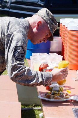 Personnel were treated to lunch of roasted ears of corn and bratwurst at the Dobbins Annual Corn and Sausage Roast held at the base lake July 18. Proceeds are donated for the Dobbins Family Readiness Programs. (U.S. Air Force photo/Don Peek)