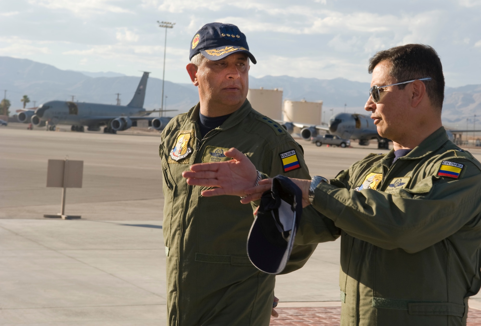 Colombia air force Gen. Tito Pinilla, commander, and Brig. Gen. Carlos Bueno, 1st Fighter Wing commander, discuss  Red Flag aerial tactics during Gen Pinilla's arrival July 24, 2012, at Nellis Air Force Base, Nev. Pinilla has been the Colombia air force commander since Sept. 9, 2011.  (U.S. Air Force photo by Airman 1st Class Matthew Lancaster)