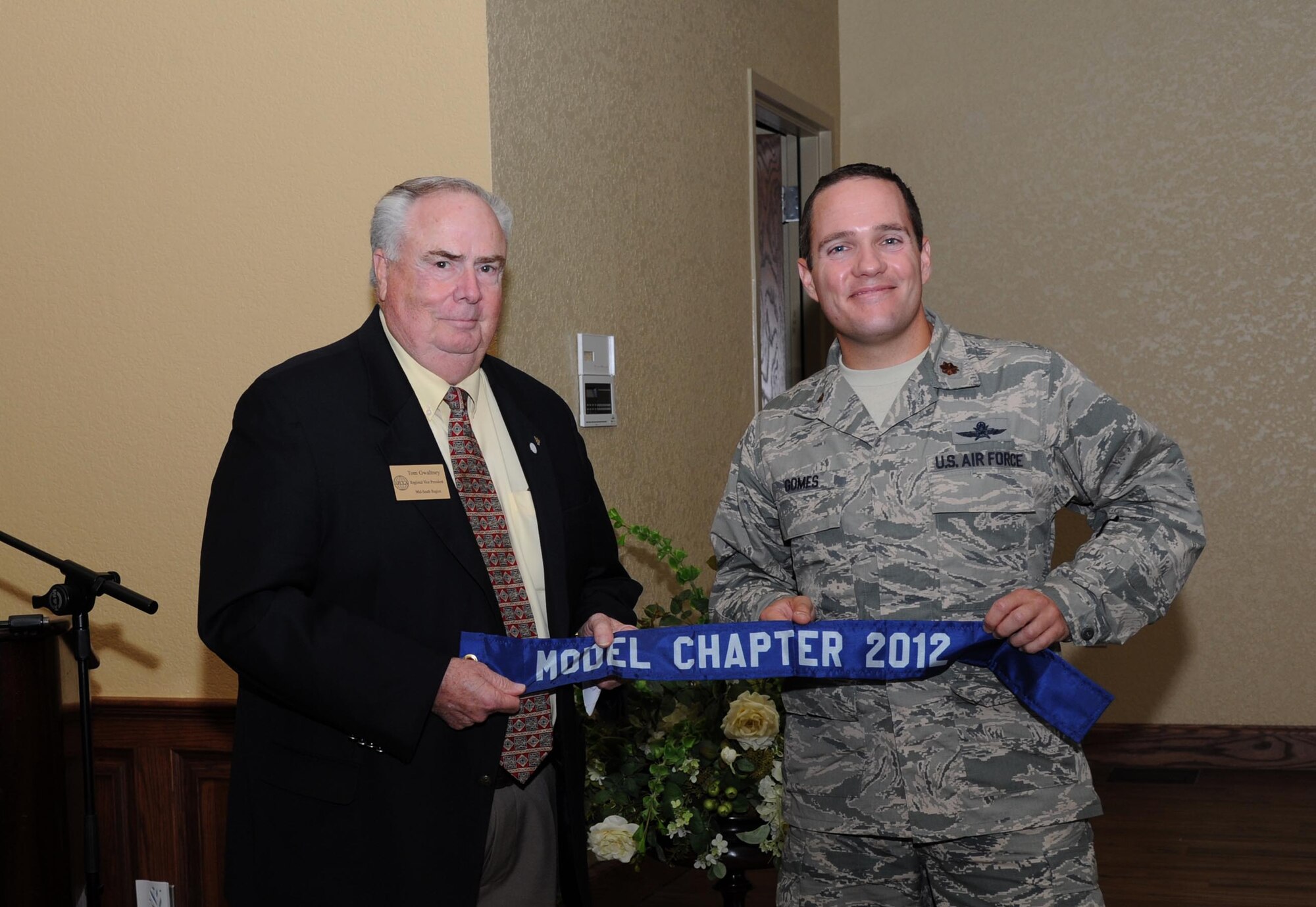 Tom Gwaltney, Armed Forces Communications and Electronics Association Regional vice president for Mid-south Region, presents the model chapter of the year award to Maj. Jeffrey Gomes, 85th Engineering and Installation Squadron commander and AFCEA Gulf Coast Chapter president, during the AFCEA luncheon July 25, 2012, at the Bay Breeze Event Center, Keesler Air Force Base, Miss.  The model chapter of the year award recognizes the top overall chapter structure and program of activities for the year.  (U.S. Air Force photo by Kemberly Groue)