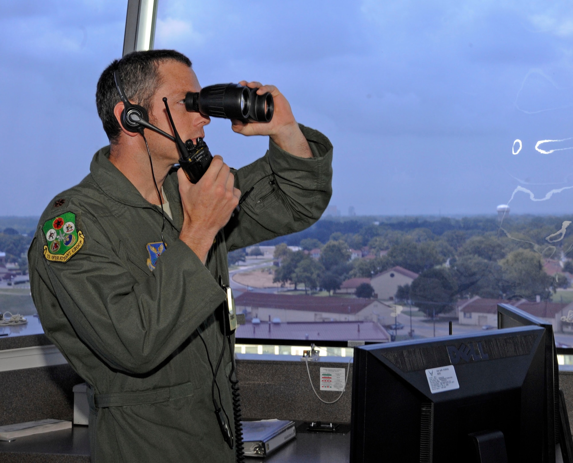 Maj. Matthew Pommer, 96th Bomb Squadron supervisor of flying, scans along the horizon from the air traffic control tower at Barksdale Air Force Base, La., July 23. The role of a SOF is to inform the operations group commander of scheduled flights and weather conditions, as well as ensure aircrew follow procedures safely. (U.S. Air Force photo/Airman 1st Class Andrew Moua)(RELEASED)