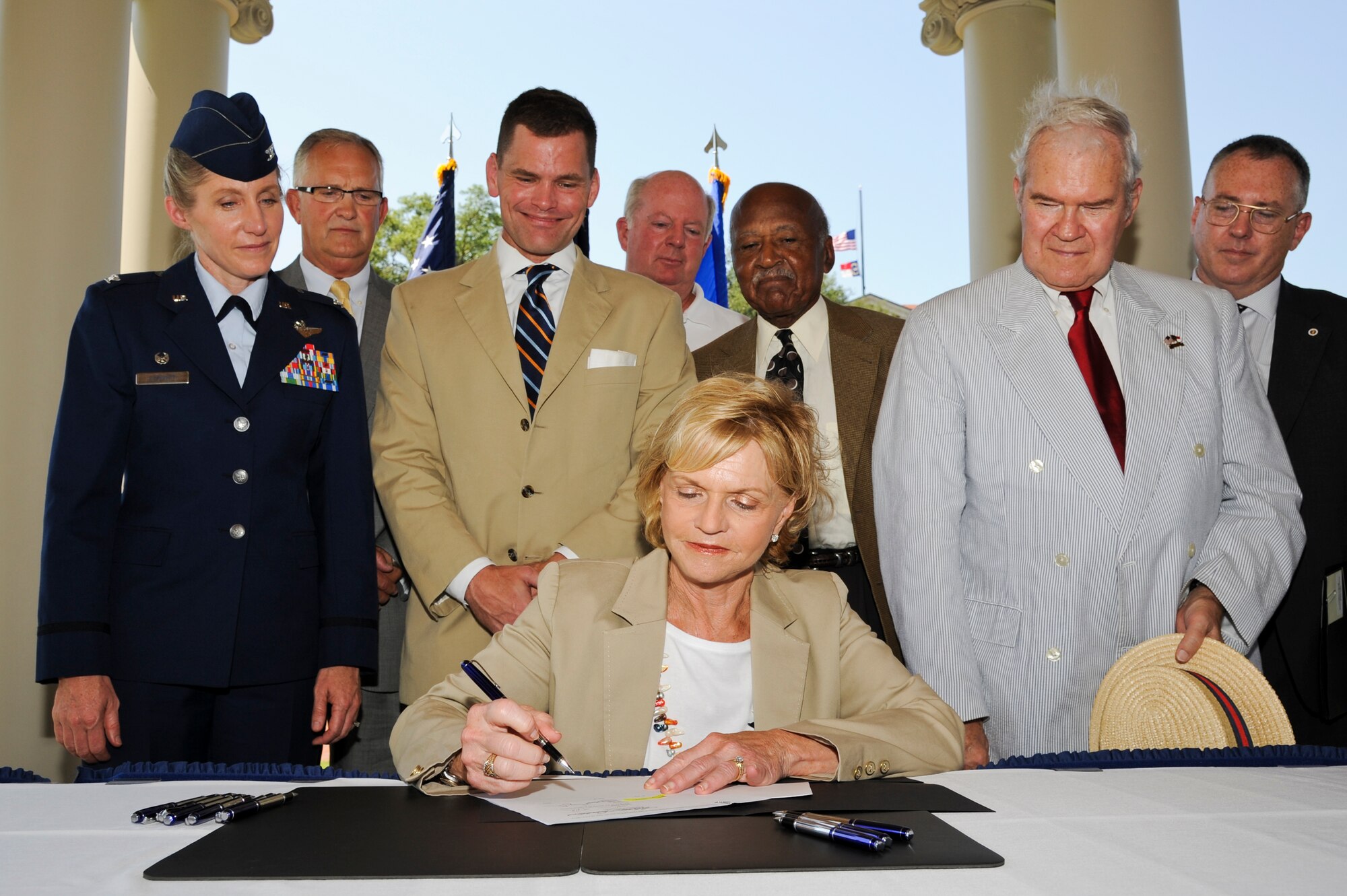 North Carolina Governor Bev Perdue signs House Bill 799 at the Wayne County Veterans Memorial in downtown Goldsboro, N.C. July 24, 2012. This bill gives military spouses and veterans, professionally licensed in other states, the opportunity to apply for their N.C. license without having to re-license. (U.S. Air Force photo/Tech. Sgt. Colette Graham/Released)