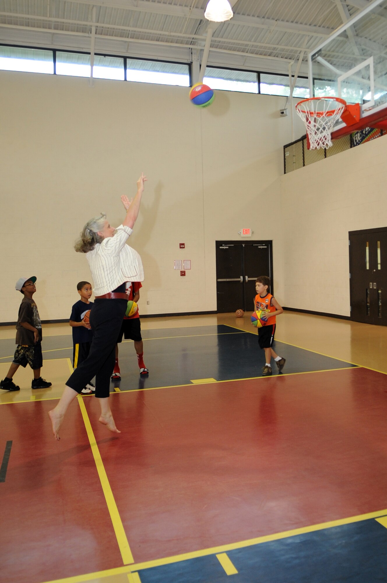 Kathy Wells, spouse of U.S. Air Force Maj. Gen. Lawrence Wells, 9th Air Force commander, shoots a basketball at the youth center on Seymour Johnson Air Force Base, N.C., July 16, 2012. The Wells visited members of Team Seymour to learn more about the 4th Fighter Wing mission and to see what challenges its Airmen and their families encounter. (U.S. Air Force photo/Airman 1st Class Aubrey Robinson/Released)