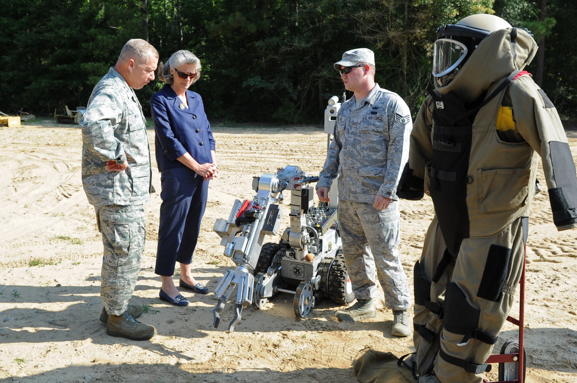 U.S. Air Force Maj. Gen. Lawrence Wells, 9th Air Force commander, and his spouse, Kathy Wells, listens to Staff Sgt. Paul Pest, 4th Civil Engineer Squadron explosive ordnance disposal journeyman, explain the capabilities of the Remotec ANDROS F6A robot  during a visit to the EOD range on Seymour Johnson Air Force Base, N.C., July 17, 2012. The general toured various work centers around the base for a first-hand view of how Airmen at the 4th Fighter Wing carry out the Air Combat Command mission. (U.S. Air Force photo/Senior Airman Gino Reyes/Released)