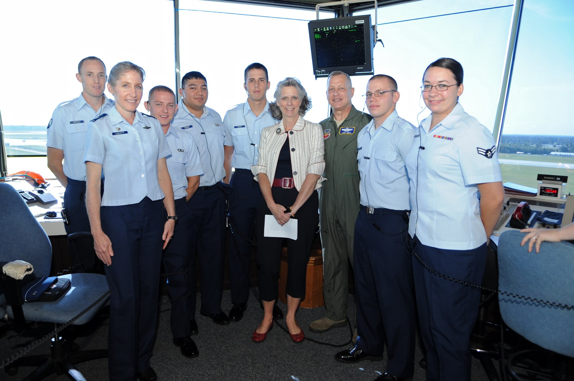 U.S. Air Force Col. Jeannie Leavitt (left), Maj. Gen. Lawrence Wells, 9th Air Force commander, and his spouse, Kathy Wells, (center) pose with Airmen from the 4th Operations Support Squadron during a tour on Seymour Johnson Air Force Base, N.C., July 16, 2012. The Wells visited various shops on base to get a good feel for how 4th Fighter Wing Airmen conduct their day-to-day operations. (U.S. Air Force photo/Airman 1st Class Aubrey Robinson/Released)