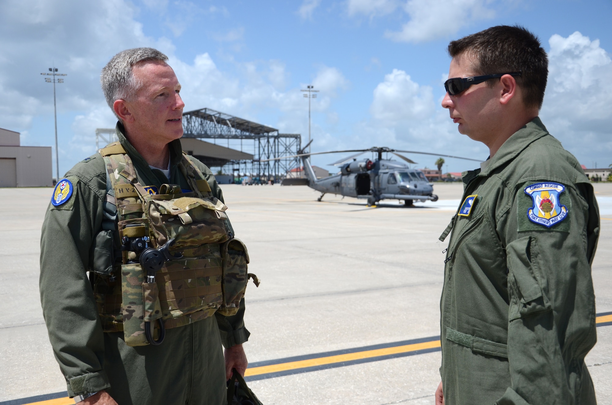 Prior to flying on an HH-60G Pave Hawk helicopter, Brig. Gen. William Binger, commander, 10th Air Force, Naval Air Station Fort Worth Joint Reserve Base, Texas is greeted and prepped by Tech. Sgt. David Bahr, flight engineer, 301st rescue squadron July 24. Airmen from the 920th Rescue Wing, Patrick Air Force Base, Fla., treated Binger to a flight on an HH-60 where he also had the opportunity to shoot from the gun fixed on the helicopter. (U.S. Air Force photo/Senior Airman Natasha Dowridge)