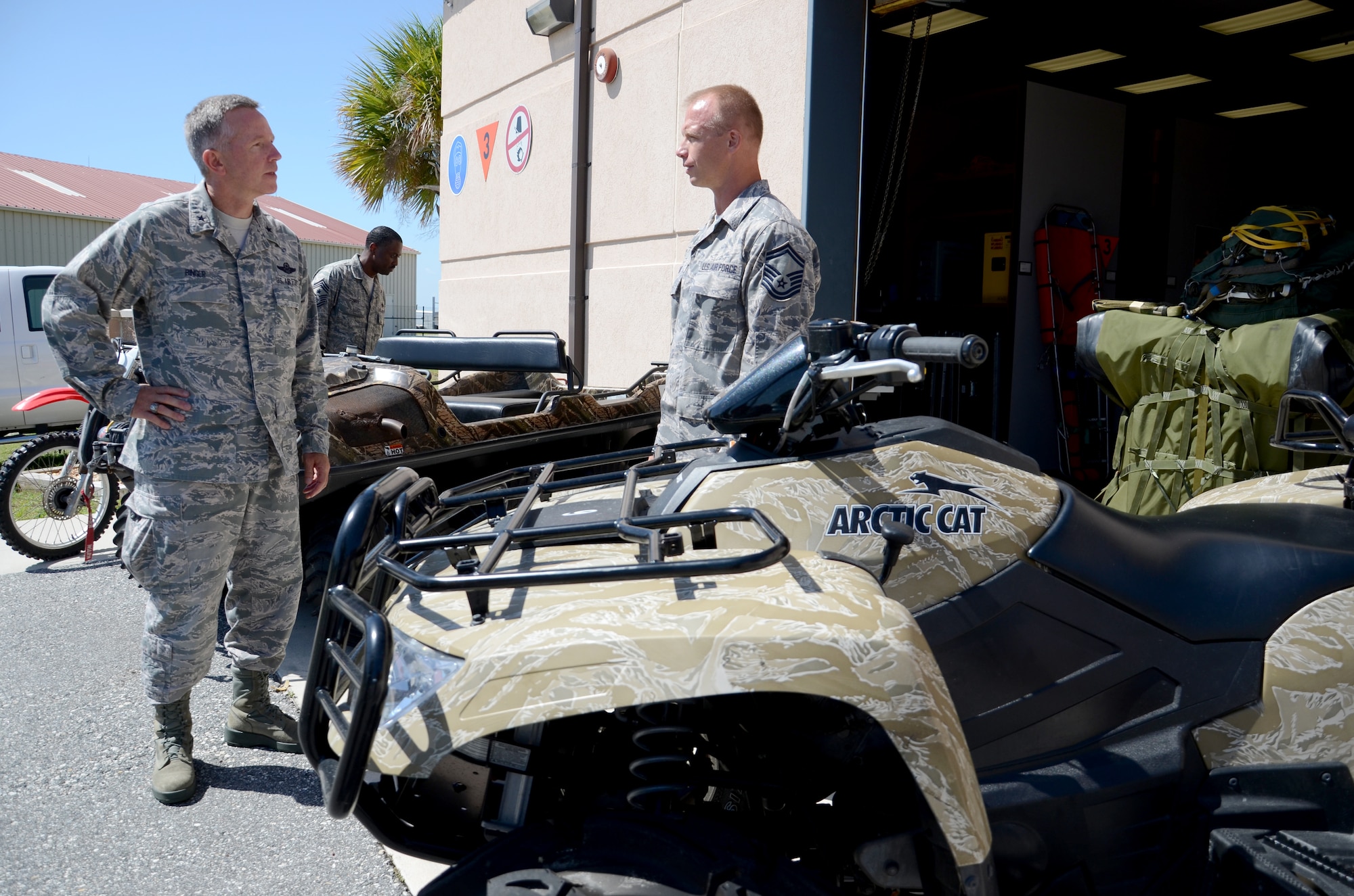 Senior Master Sgt. John Grant, pararescueman, 308th rescue squadron, explains how the pararescuemen of the 920th Rescue Wing, Patrick Air Force Base, Fla., utilize the various vehicles displayed outside the squadron to Brig. Gen. William Binger, 10th Air Force commander during a wing tour July 25. Binger visited Airmen from the pararescue squadron, maintenance and air crew over a two day period. (U.S. Air Force photo/Senior Airman Natasha Dowridge)
