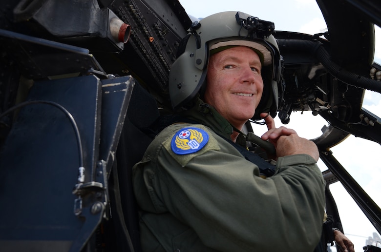 Brig. Gen. William Binger, commander, 10th Air Force, Naval Air Station Fort Worth Joint Reserve Base, Texas, straps on his helmet before taking off in a 920th Rescue Wing HH-60G Pave Hawk helicopter while visiting the wing July 25. Binger visited Rescue Reservists to get a better understanding wing's combat search and rescues mission. (U.S. Air Force photo/Senior Airman Natasha Dowridge)