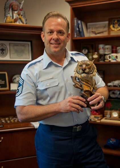 U.S. Air Force Chief Master Sgt. Eddie McAnally, 23d Mission Support Group chief enlisted manager, holds the head of “The Tiger’s Pride Trophy,” which is given to the squadron with the most spirit during their fun runs, July 23, 2012, at Moody Air Force Base, Ga. The first MSG Fun Run was held July 20 and will be held  each quarter.  (U.S. Air Force photo by Senior Airman Eileen Meier/Released)