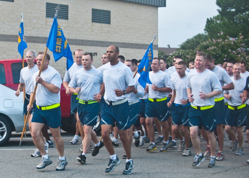 U.S. Air Force Chief Master Sgt. Eddie McAnally, 23d Mission Support Group chief enlisted manager, leads a formation run holding the guidon during the MSG Fun Run July 20, 2012, at Moody Air Force Base, Ga. A fun run will be held every quarter, and squadrons will compete for the “Tiger’s Pride Trophy,” which is awarded to the squadron who can portray the most motivation by shouting and showing spirit. (U.S. Air Force photo by Senior Airman Eileen Meier/Released) 